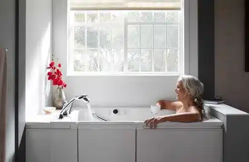 woman bathing in a kohler walk in bath